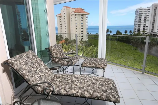a view of balcony with a couple of chairs