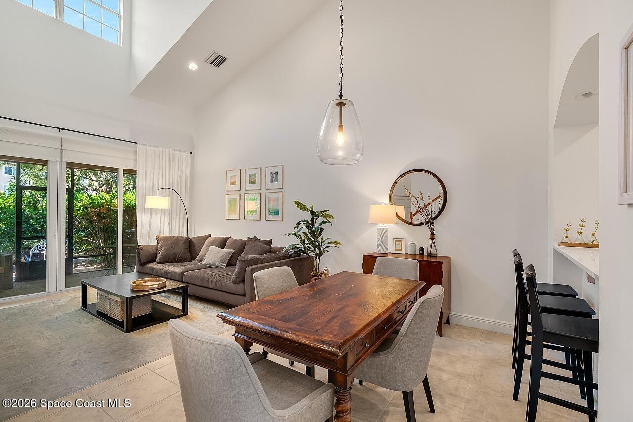 1629 Baseline Lane Vero Beach, FL 32967 - Photo 1 of 29 a living room with furniture a chandelier and a floor to ceiling window