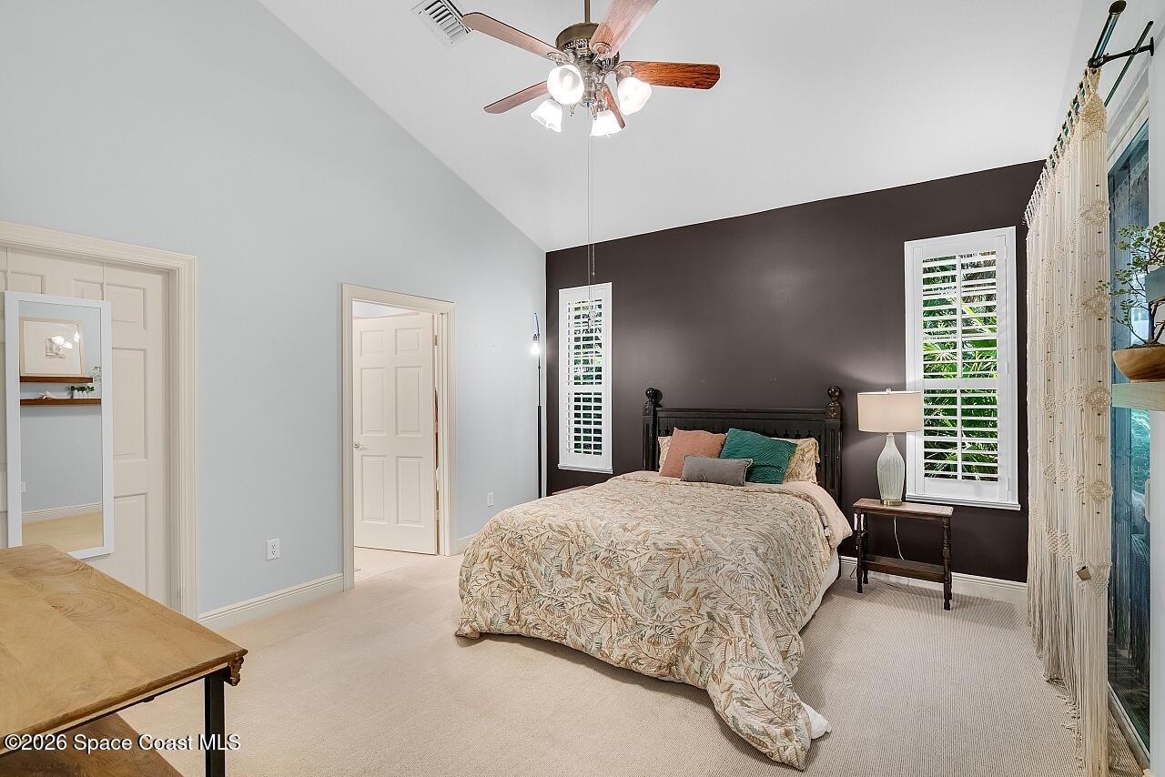 1629 Baseline Lane Vero Beach, FL 32967 - Photo 11 of 29 a bedroom with a bed and a chandelier