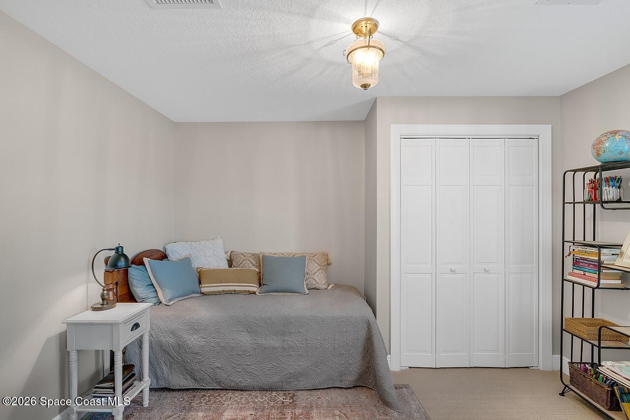 1629 Baseline Lane Vero Beach, FL 32967 - Photo 21 of 29 a bedroom with bed and a book shelf