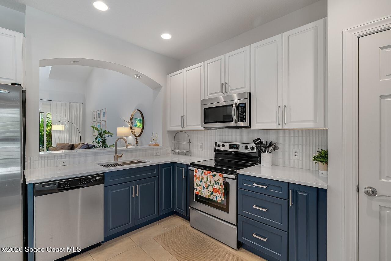 1629 Baseline Lane Vero Beach, FL 32967 - Photo 5 of 29 a kitchen with sink a microwave and cabinets