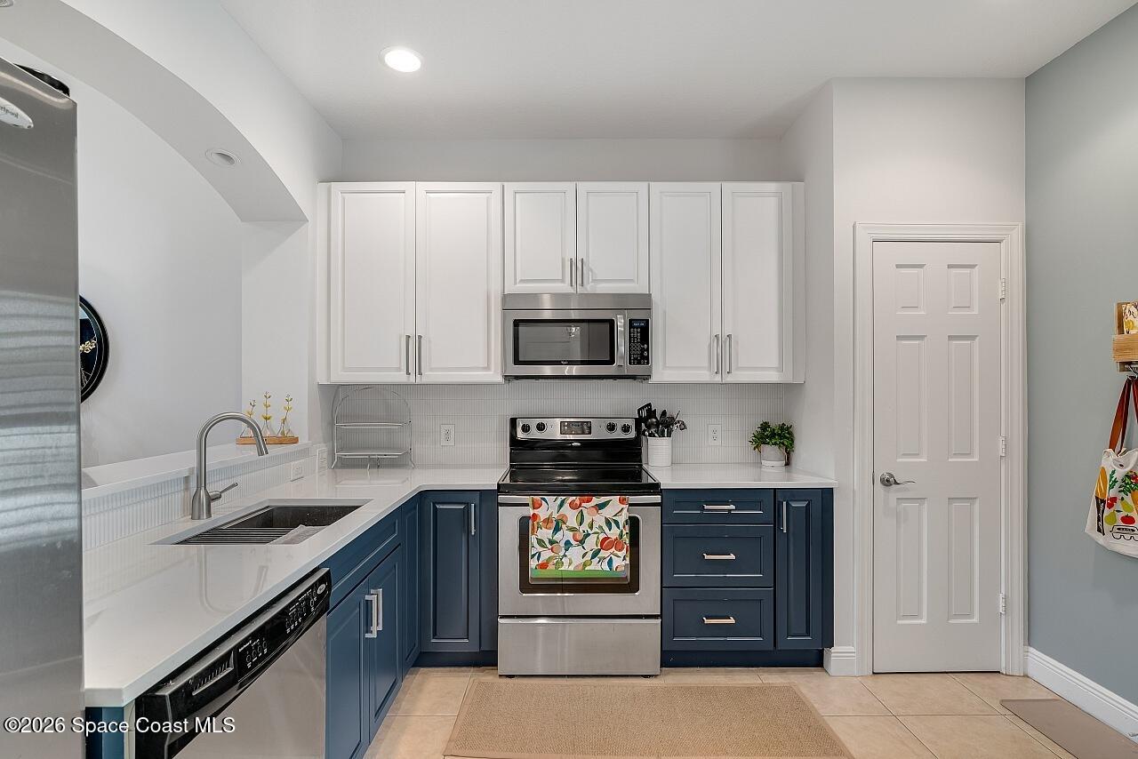 1629 Baseline Lane Vero Beach, FL 32967 - Photo 6 of 29 a kitchen with stainless steel appliances granite countertop a stove and a refrigerator