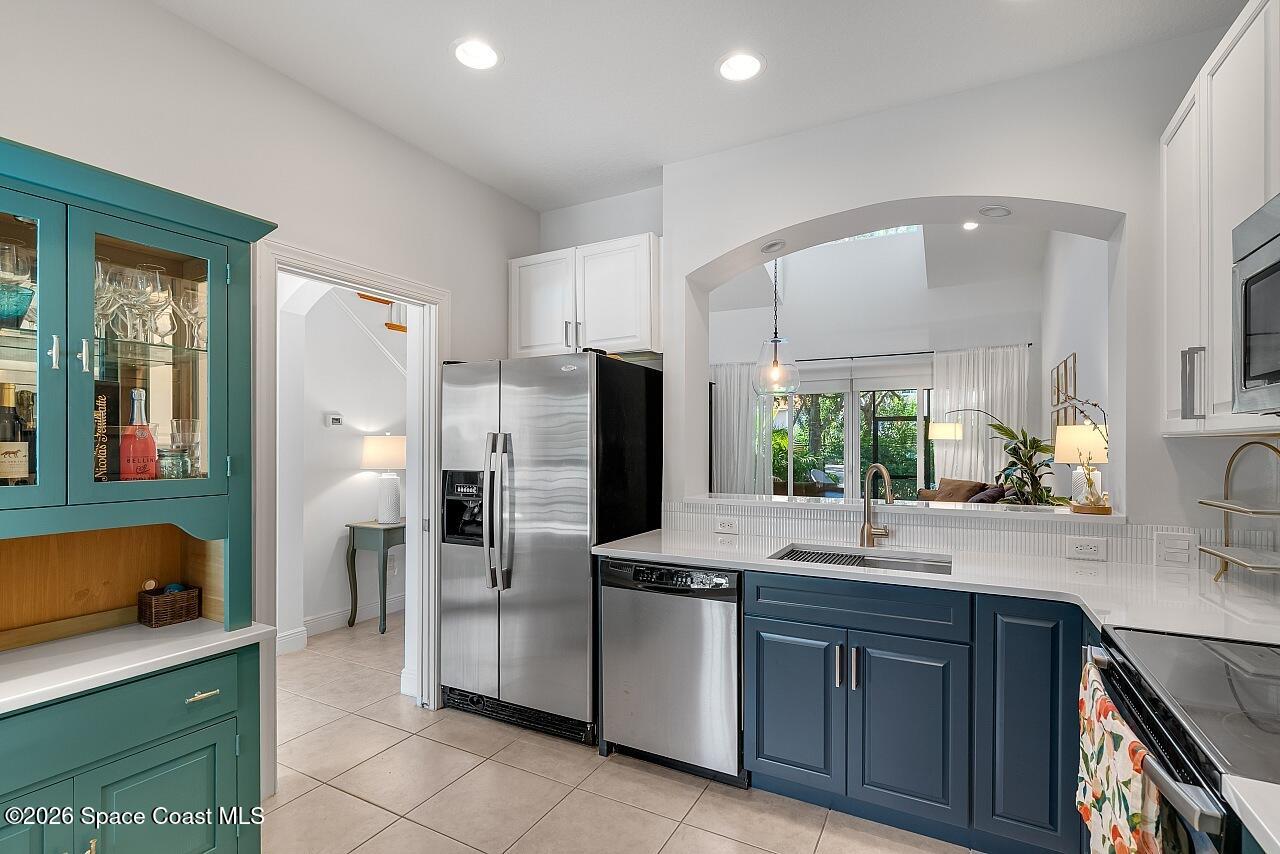 1629 Baseline Lane Vero Beach, FL 32967 - Photo 7 of 29 a kitchen with stainless steel appliances a sink stove and refrigerator