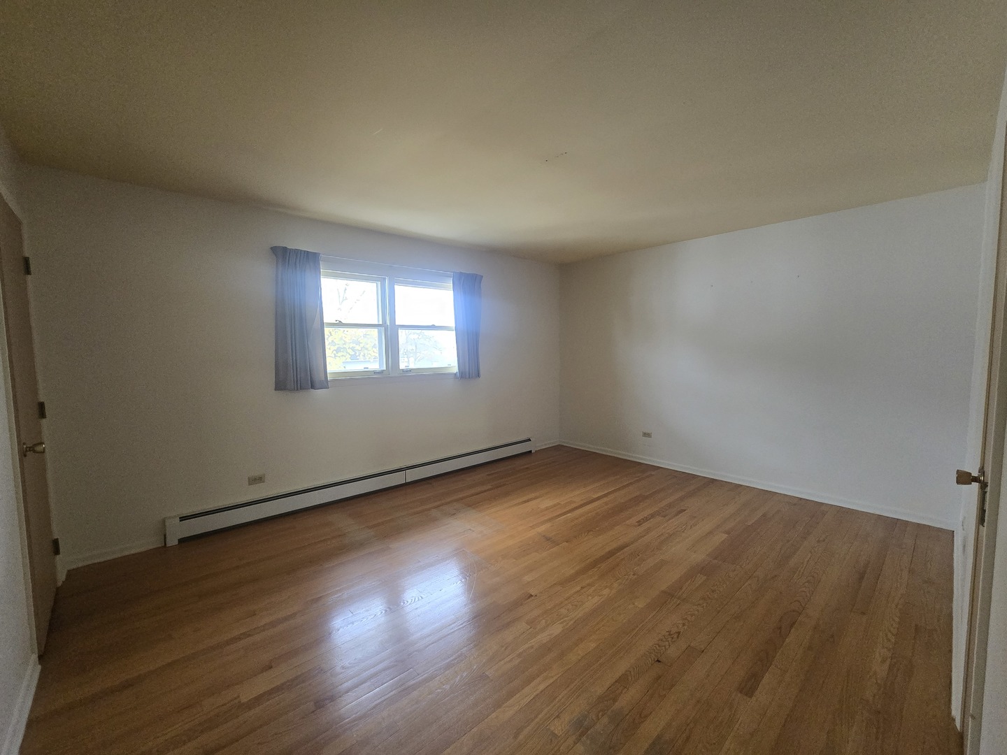333 Ida Avenue, Unit 3 Antioch, IL 60002 - Photo 6 of 9 an empty room with wooden floor and windows