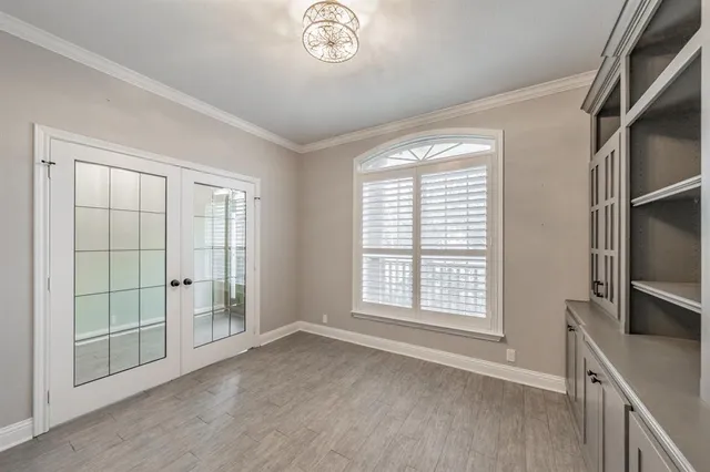 an empty room with windows and closet