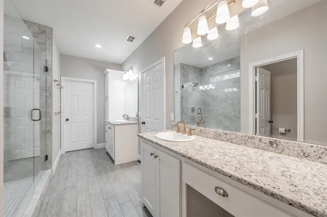 a bathroom with a shower and a sink