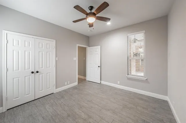 a bathroom with a granite countertop sink toilet and mirror