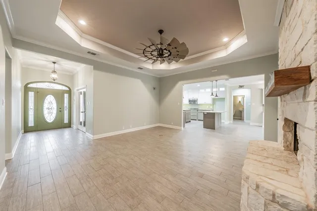 a living room with furniture a fireplace and a flat screen tv