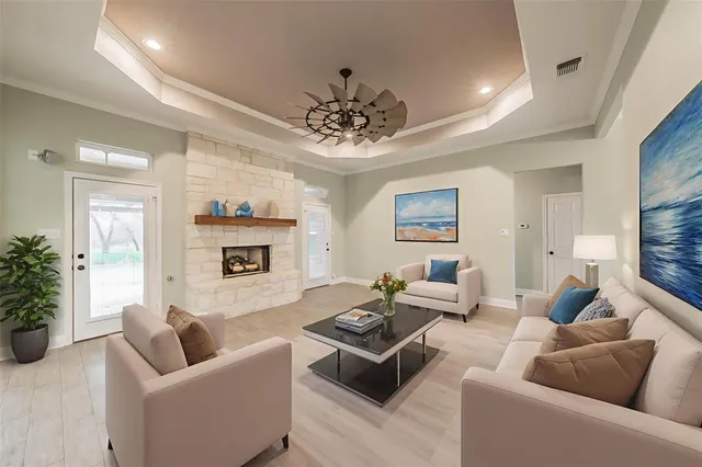a view of an empty room with a fireplace and a window