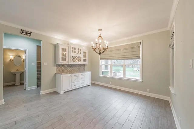 a kitchen with kitchen island a sink stove and refrigerator