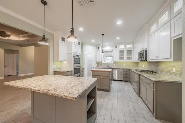 a kitchen with a sink stove and cabinets