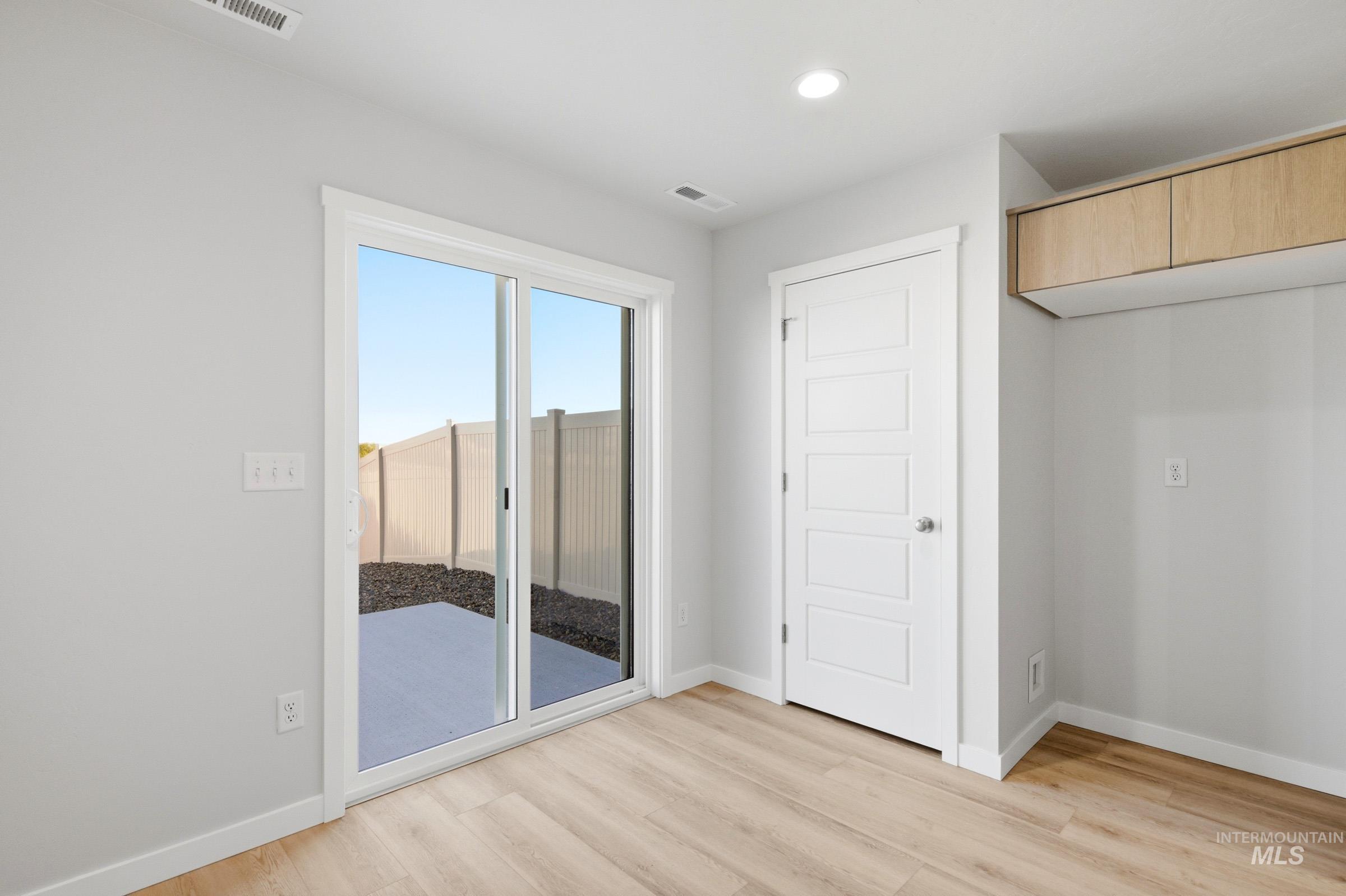 10800 Rutland Street Caldwell, ID 83605 - Photo 8 of 21 Light wood-finish flooring with crisp white baseboards and trim