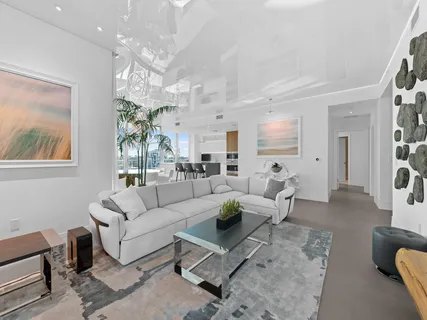 a living room with furniture dining area and a chandelier