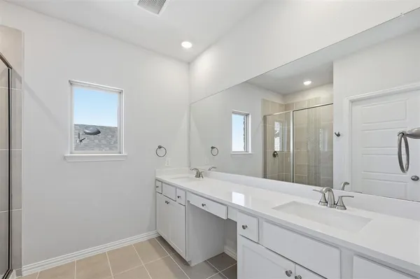 a bathroom with a double vanity sink mirror and double