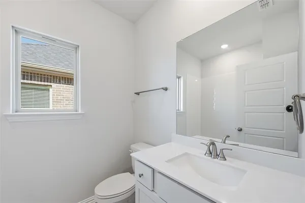 a bathroom with a sink toilet and vanity