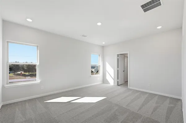 an empty room with windows and closet