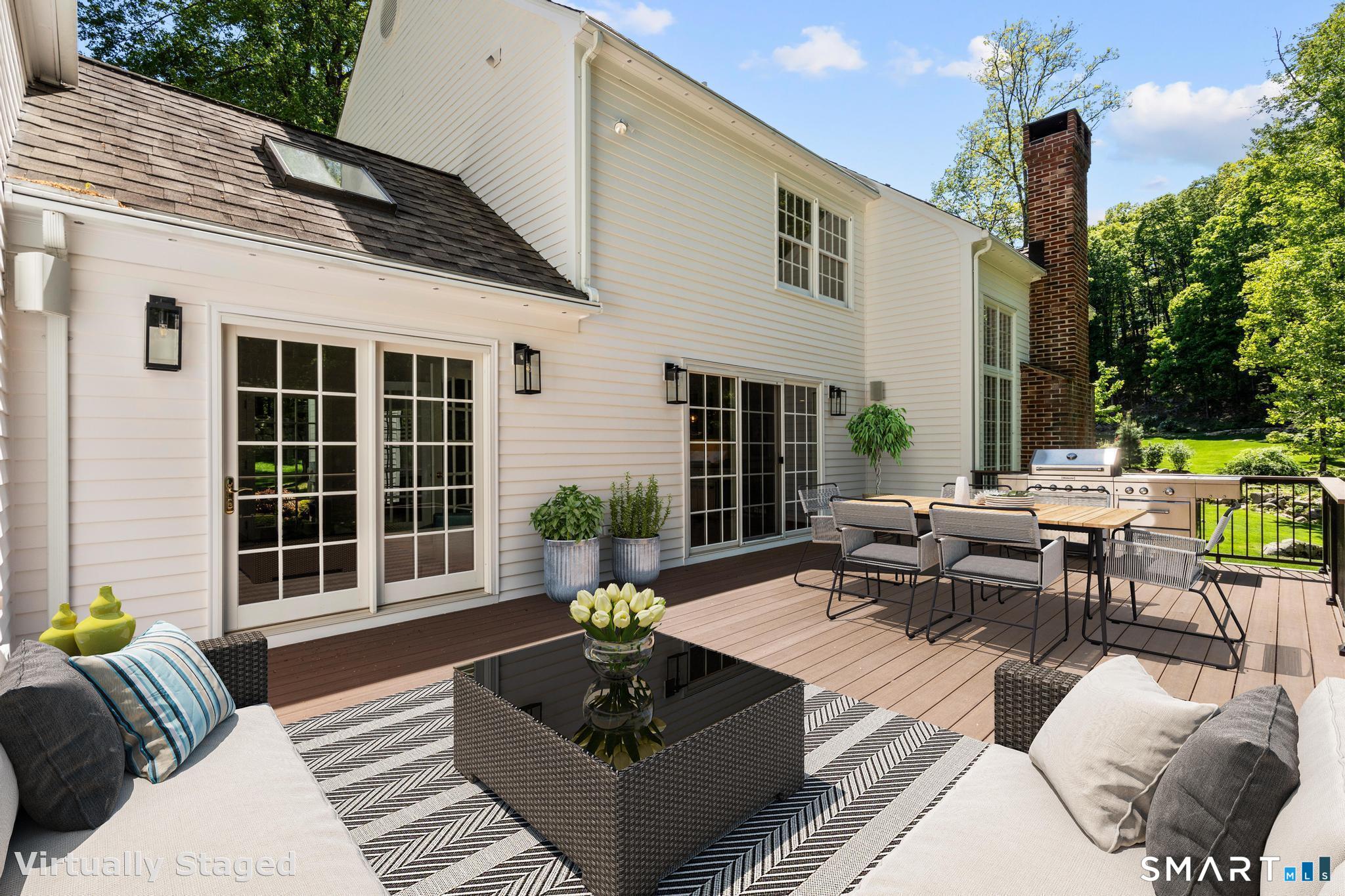 181 Old Branchville Road Ridgefield, CT 06877 - Photo 37 of 40 a view of a patio with couches and a table and chairs with floor to ceiling window and potted plants