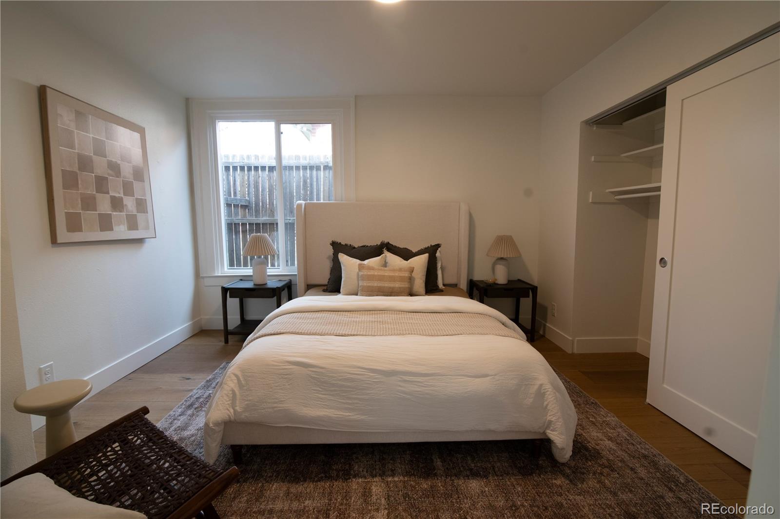 2831 Perry Street Denver, CO 80212 - Photo 15 of 29 a large bed sitting in a bedroom next to a window