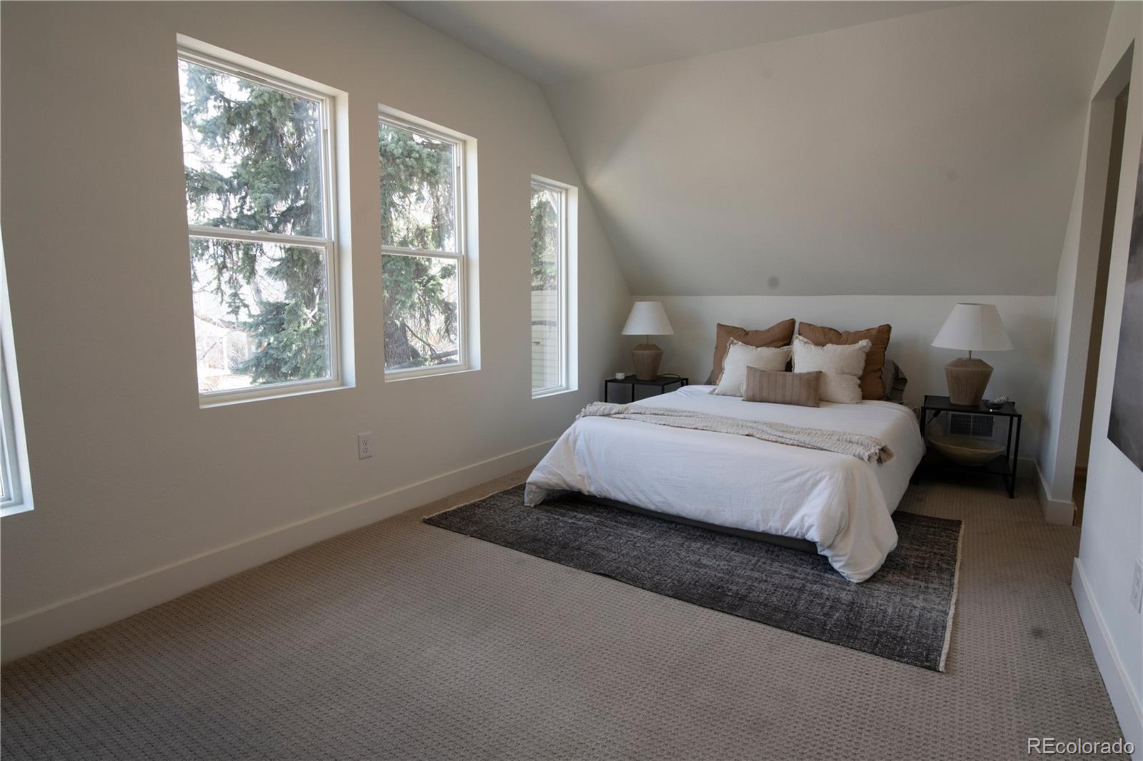 2831 Perry Street Denver, CO 80212 - Photo 16 of 29 a bedroom with a bed lamp and window