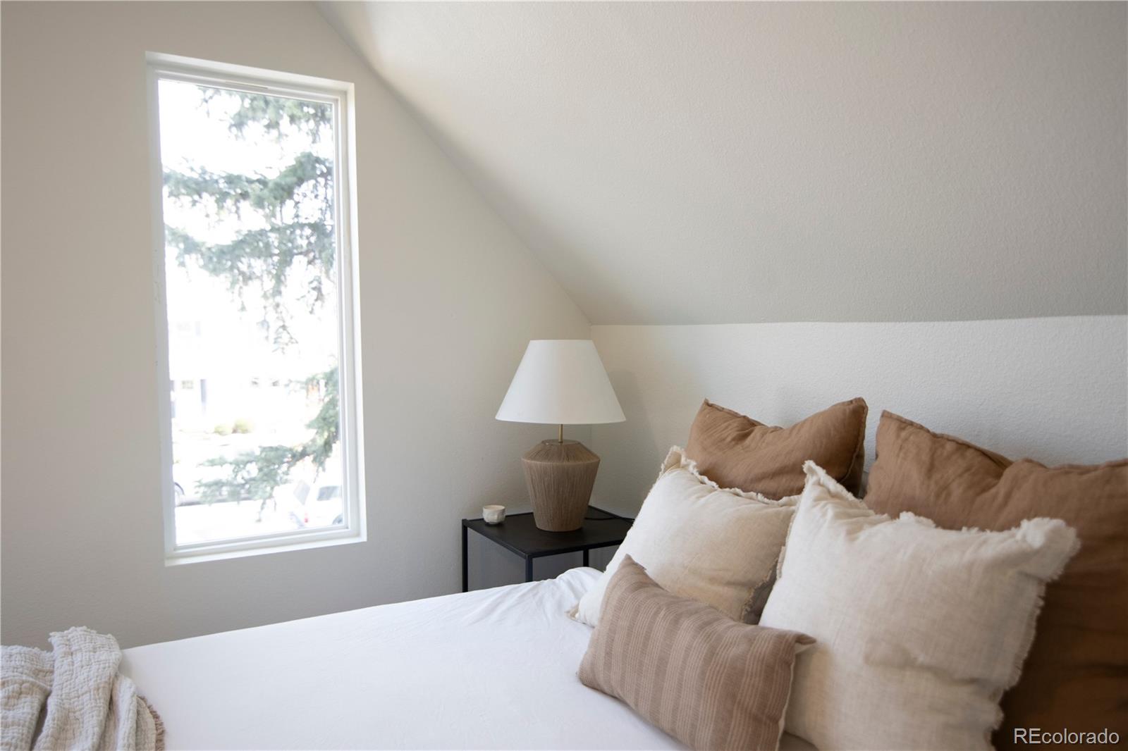 2831 Perry Street Denver, CO 80212 - Photo 17 of 29 a bedroom with a bed and a window