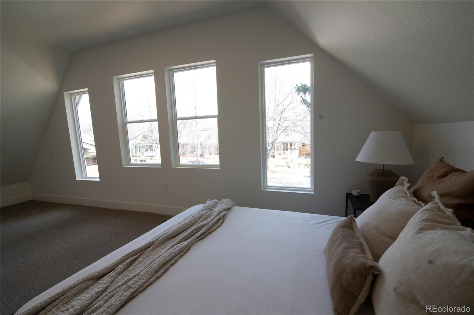 2831 Perry Street Denver, CO 80212 - Photo 18 of 29 a bed sitting in a bedroom next to a window