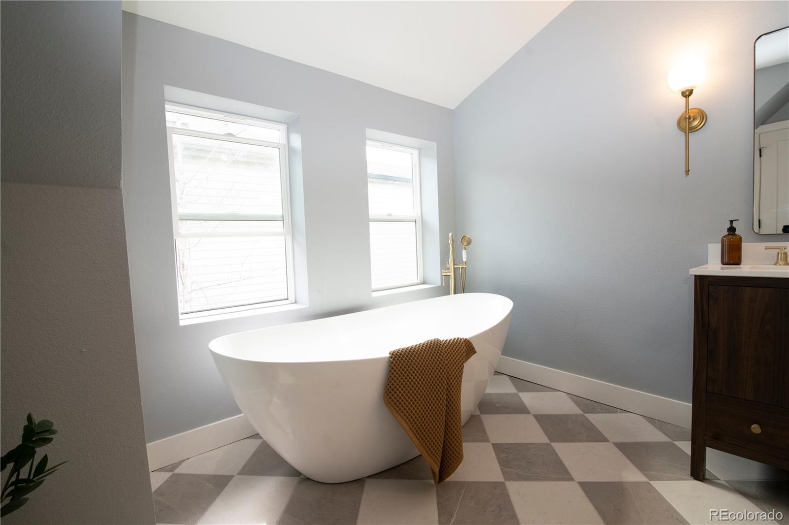 2831 Perry Street Denver, CO 80212 - Photo 19 of 29 a white bath tub sitting in a bathroom next to a window