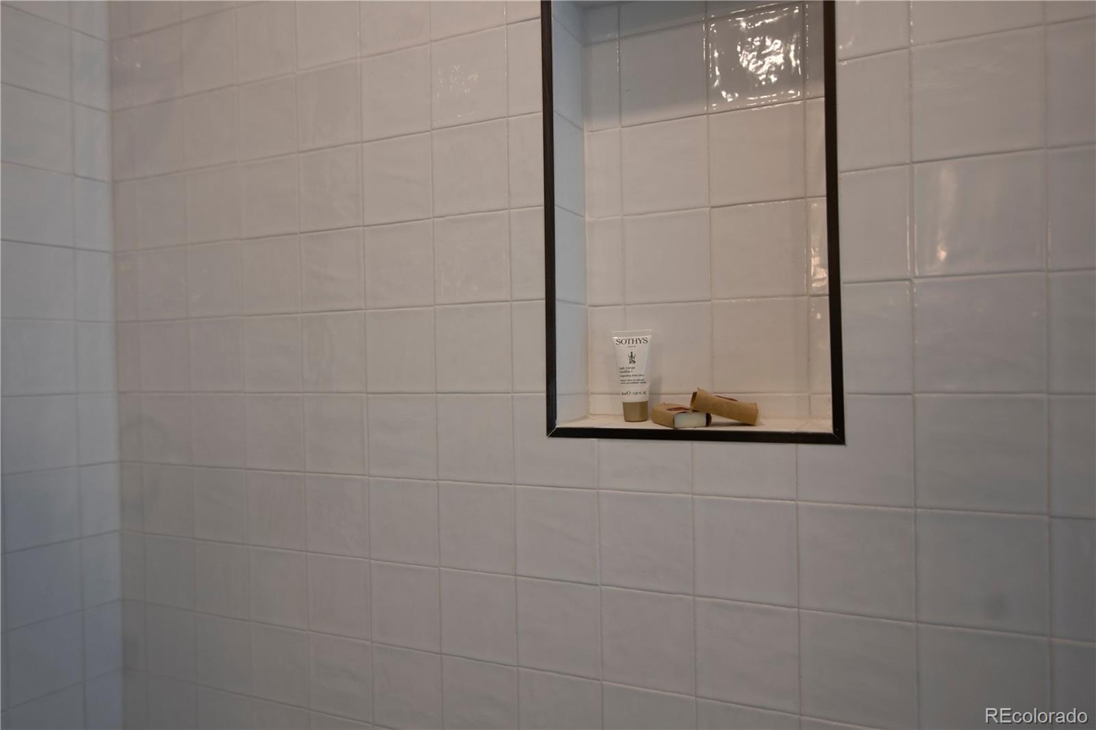 2831 Perry Street Denver, CO 80212 - Photo 22 of 29 a bathroom with a shower and a mirror