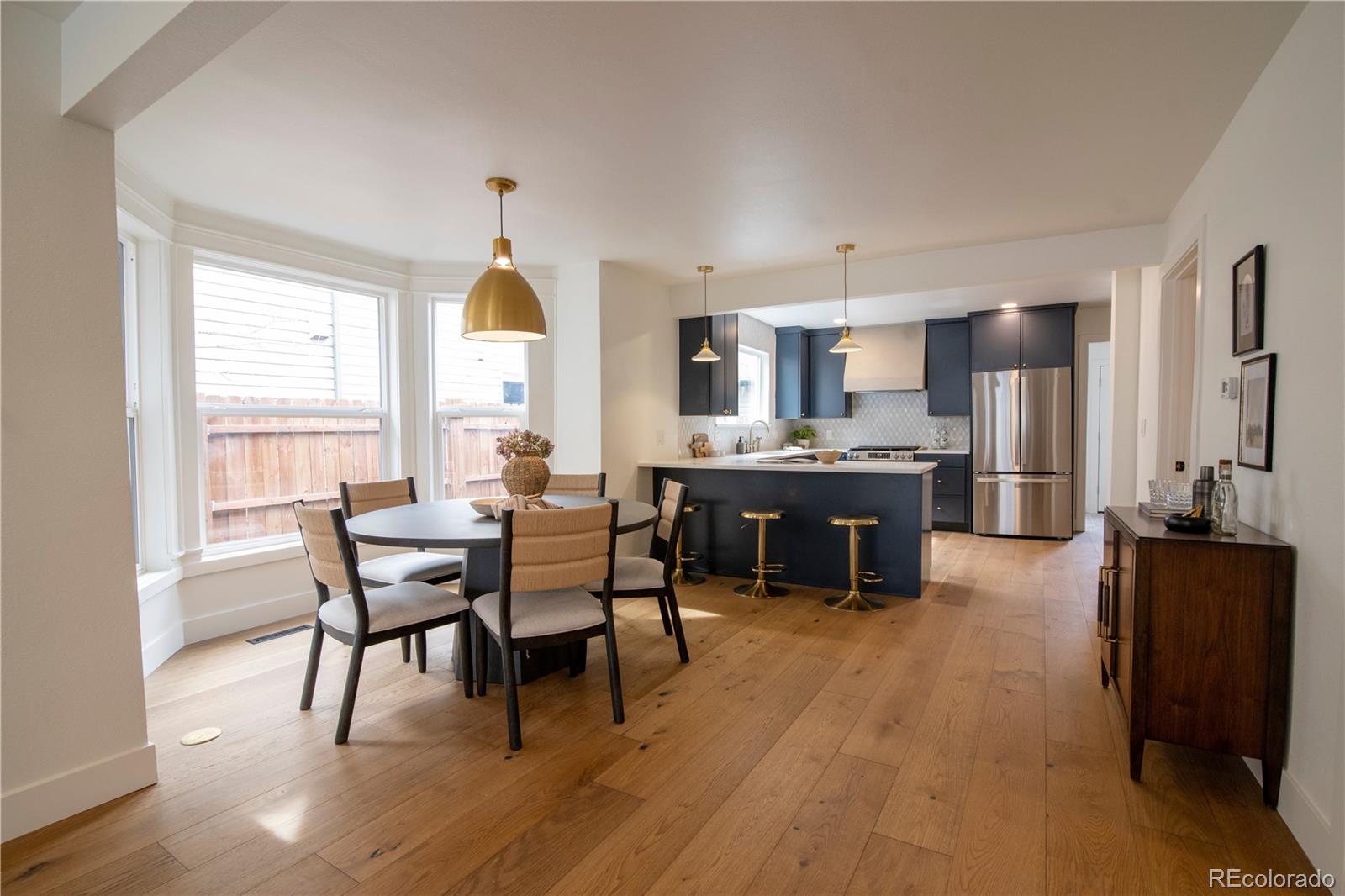 2831 Perry Street Denver, CO 80212 - Photo 6 of 29 a living room with stainless steel appliances kitchen island granite countertop furniture and a wooden floor