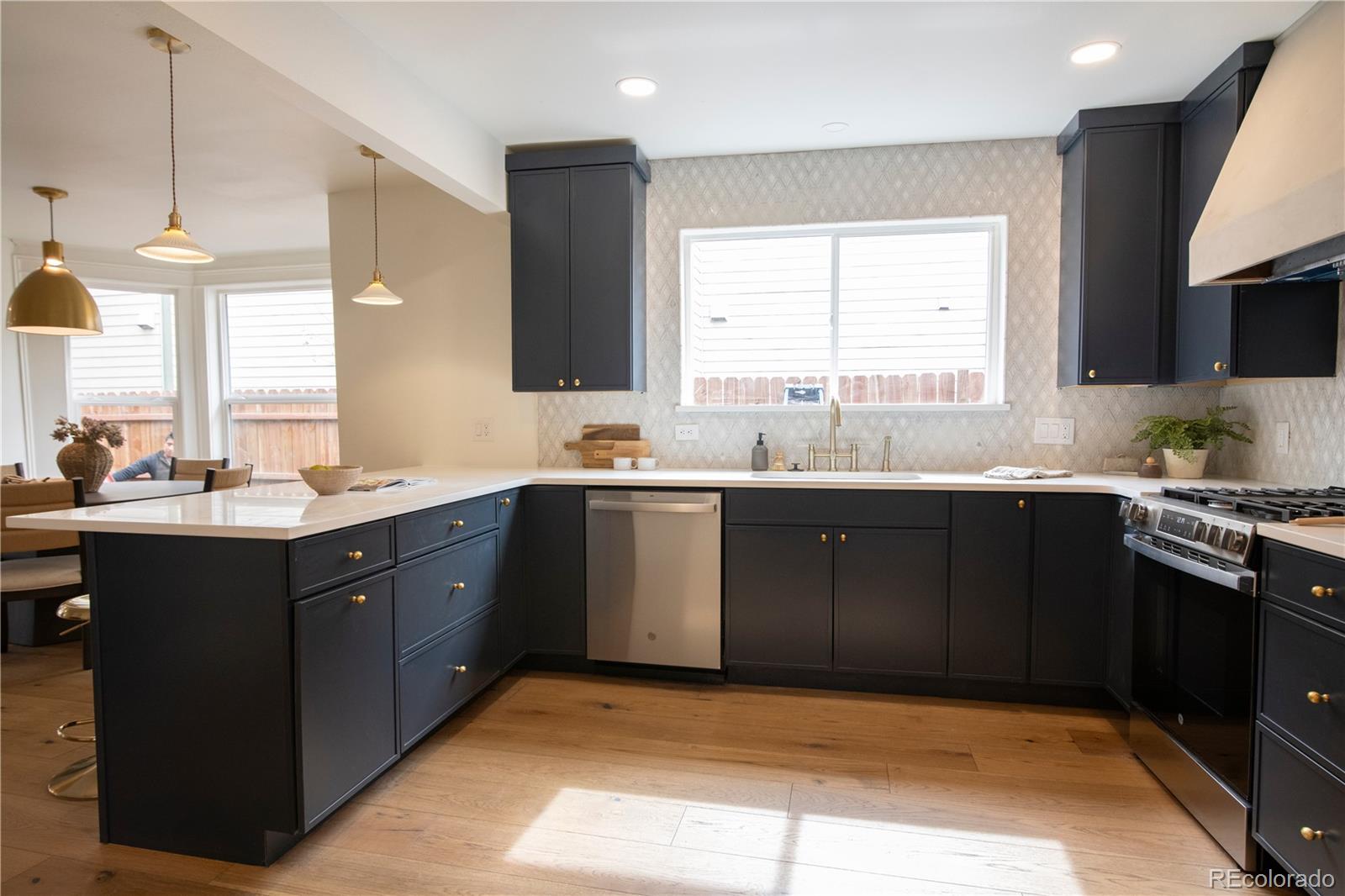 2831 Perry Street Denver, CO 80212 - Photo 8 of 29 a kitchen with a sink stove and cabinets