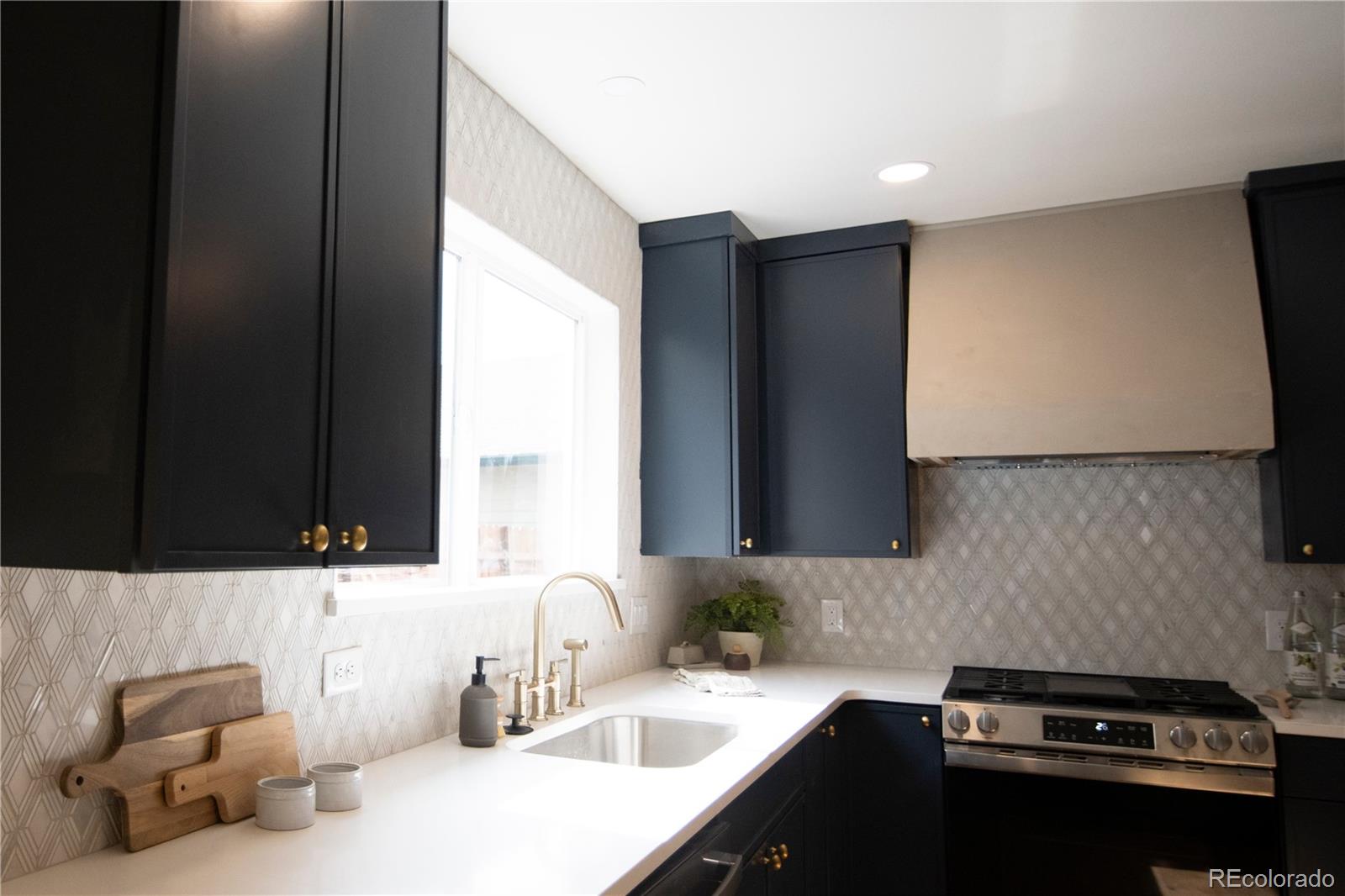 2831 Perry Street Denver, CO 80212 - Photo 9 of 29 a kitchen with a sink and a stove top oven