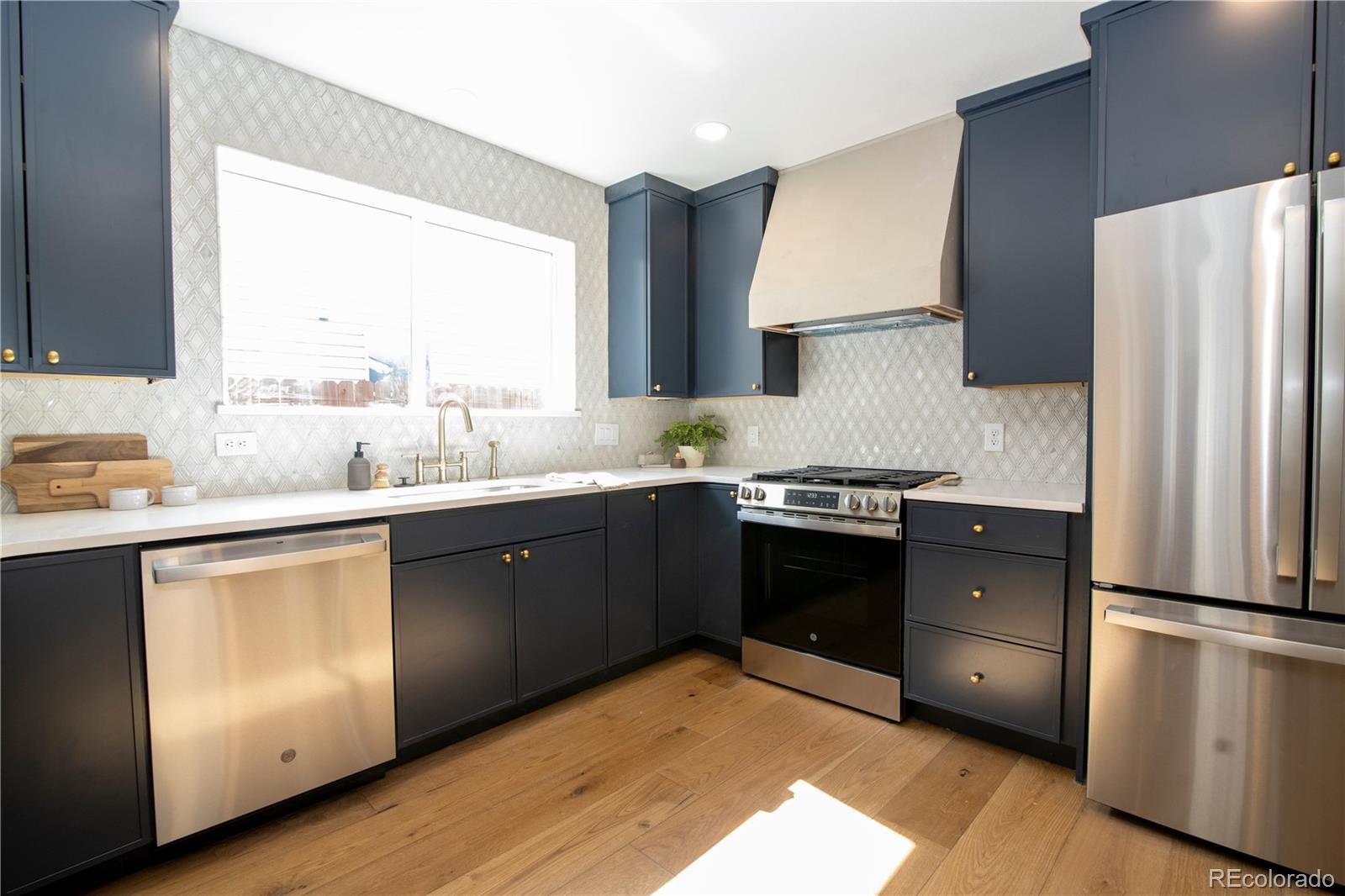 2831 Perry Street Denver, CO 80212 - Photo 10 of 29 a kitchen with a refrigerator stove and sink