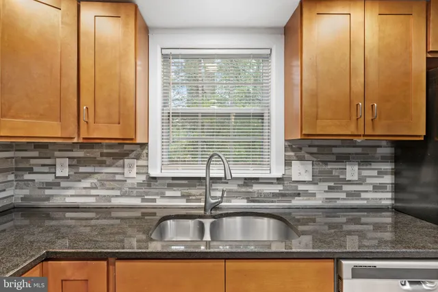 a kitchen with granite countertop a sink and a window