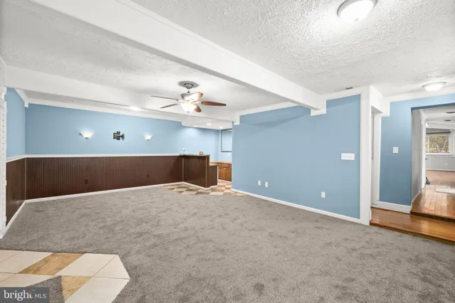 a view of a livingroom with a furniture and chandelier fan
