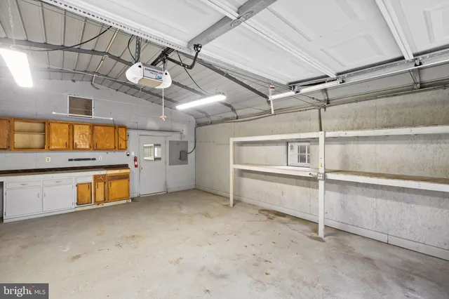 a view of a kitchen with a refrigerator and a sink