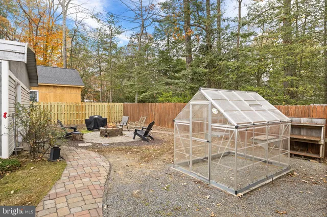 a view of a patio with a table and chairs next to a yard