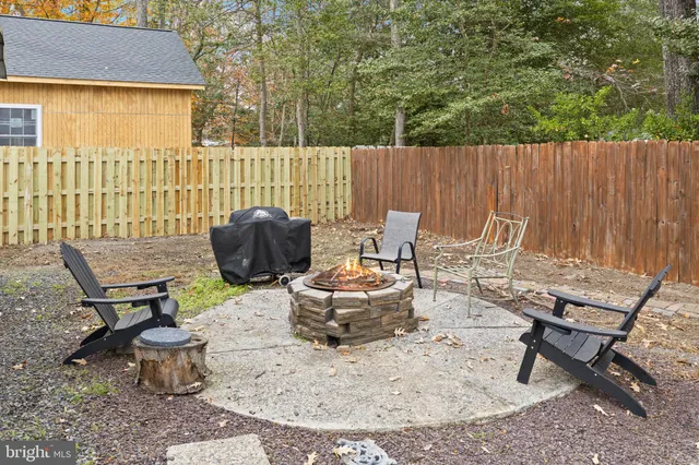 a view of a chairs and table in backyard