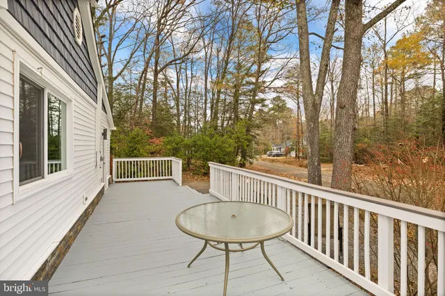a view of a chair and tables in the balcony