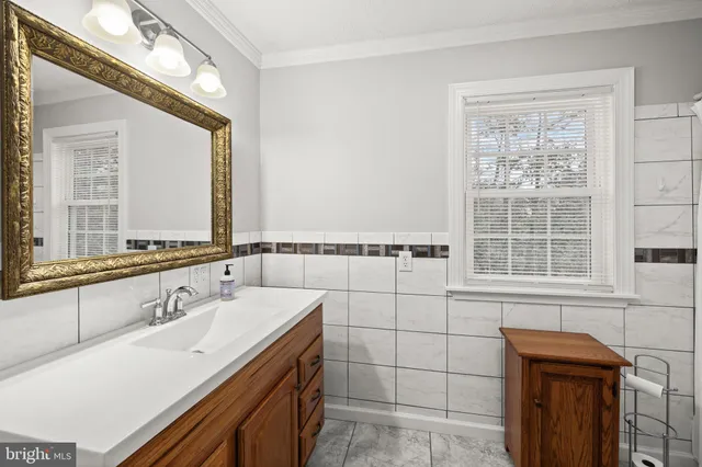 a bathroom with a sink and a window