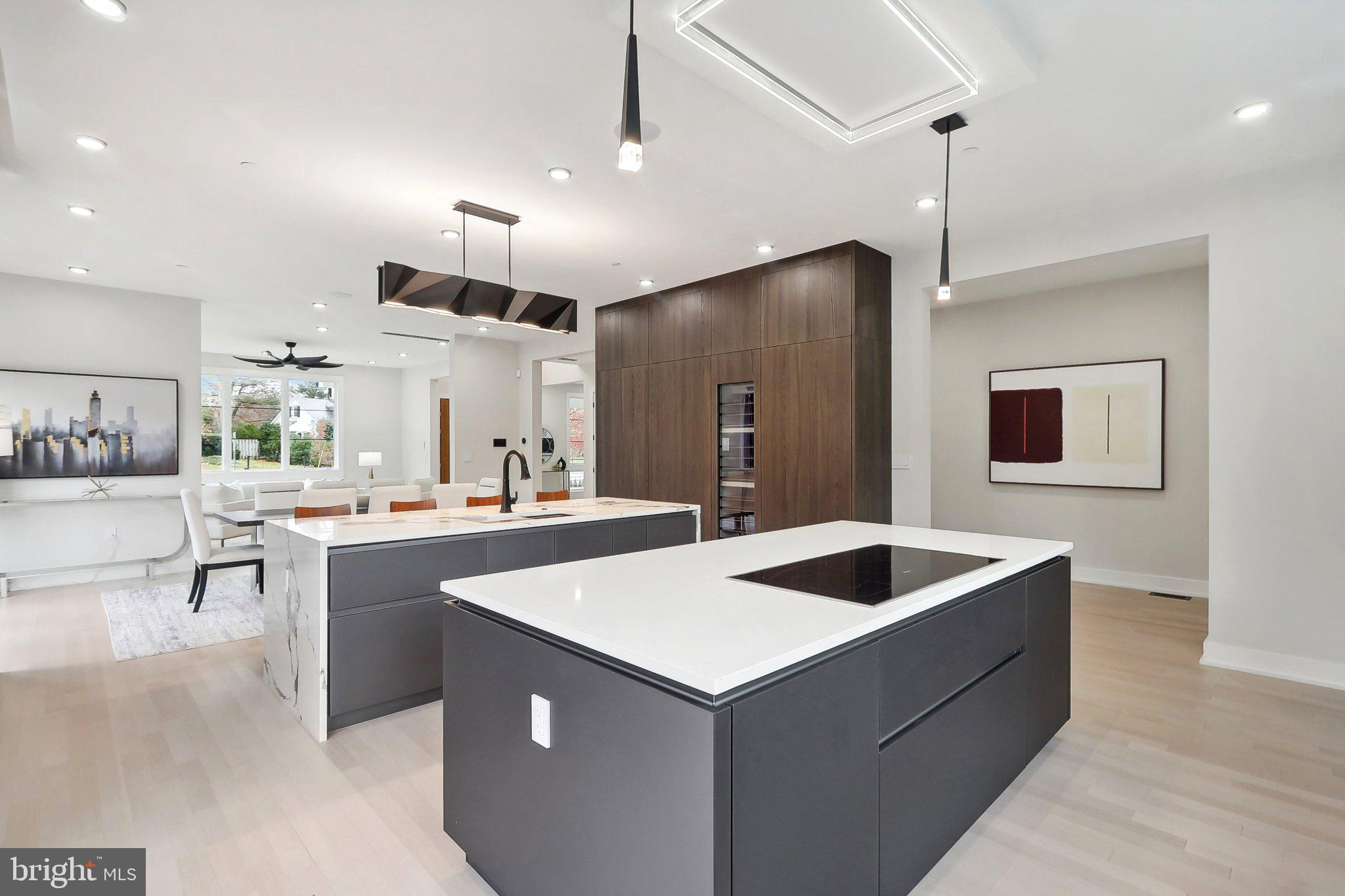 a kitchen with kitchen island a sink a counter space and stainless steel appliances
