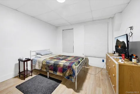 a bedroom with a bed and flat screen tv