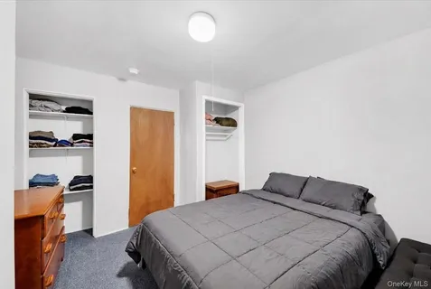 a bedroom with a bed and cabinets