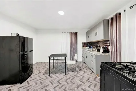 a kitchen with granite countertop a refrigerator stove and sink