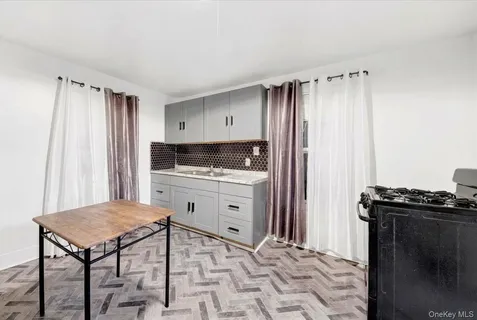 a kitchen with a stove a sink and a refrigerator