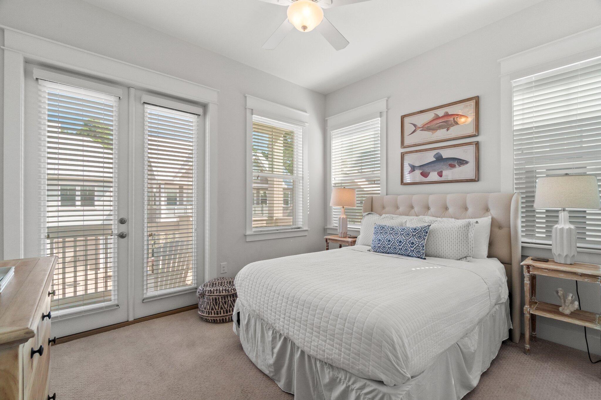 89 Pine Lands Loop Inlet Beach, Unit C Inlet Beach, FL 32461 - Photo 14 of 65 a bedroom with a bed and a chandelier