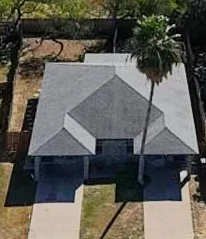 an aerial view of a house with a yard