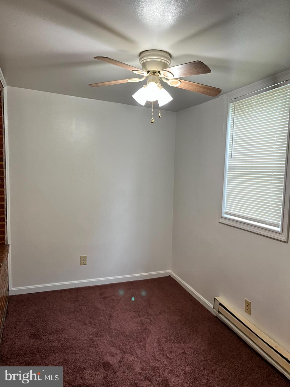 1641 V Street Southeast, Unit 2 Washington, DC 20020 - Photo 10 of 16 an empty room with a chandelier fan and windows