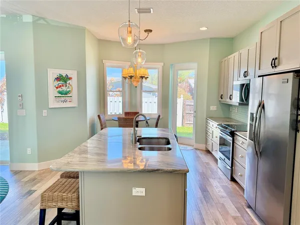 a bedroom with a large bed and a chandelier
