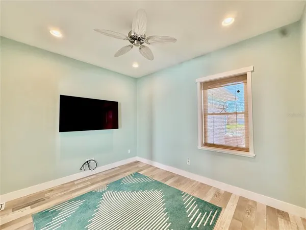 a view of a bedroom with wooden floor and bathroom