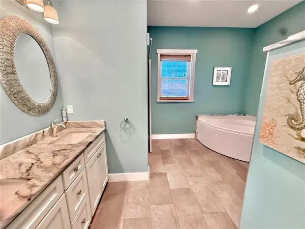 a hallway with a sink and cabinets