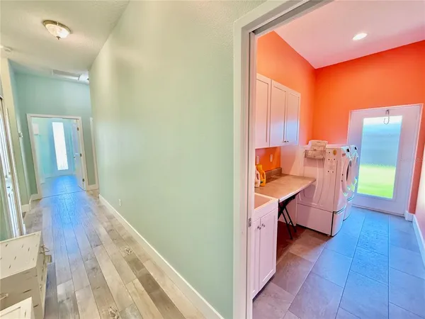 a view of a backyard with plants and large trees